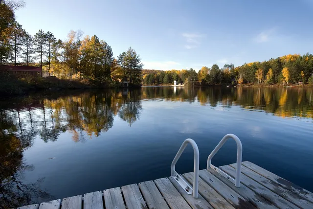 A cottage dock on a lake in autumn, Ontario.