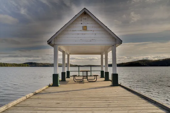 A wooden pier and small lakeside cabin on Lake of Bays, Muskoka.