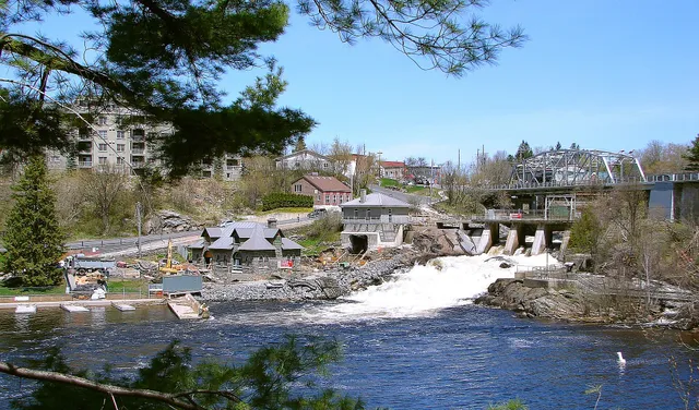The town of Bracebridge, Ontario, with its steel bridge, falls and buildings climbing the hill.